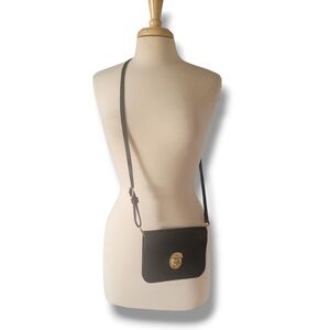Black Cross Body Mini Bag with Gold Colored Clasp.
